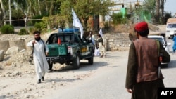 Members of the Taliban inspect the site of a blast in Jalalabad on September 18.