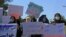 Afghan women hold placards as they take part in a protest in Herat on September 2.