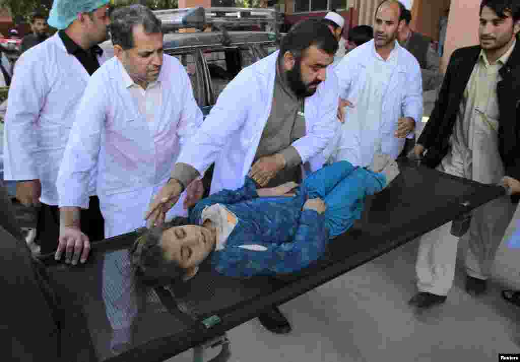 Rescue workers move an injured girl at a hospital in Jalalabad, Afghanistan.