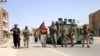 Armed Afghan security officers stand guard at a checkpoint in Herat's Guzara district on July 30. 