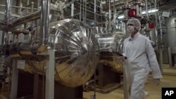  An Iranian security official in protective clothing walks through part of the Uranium Conversion Facility just outside of Isfahan. (file photo)