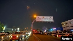 Traces of missiles are seen in the sky over Doha, Qatar, after Iran's armed forces say they targeted the Al-Udeid air base on June 23.