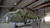 A U.S. Air Force soldier gives explanations to a group of Afghan translators for the Afghan National Army Air Corps on the Russian Mi-17 transport helicopter at a hangar in Kandahar air base in October 2009.
