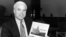 U.S. Rep. John McCain III, R-Ariz., holds a photo of a marker in Hanoi at Truc Bach Lake where he parachuted after being shot down as a Navy pilot in the Vietnam War, February 18, 1985