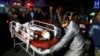 Afghan health workers bring an injured person to the hospital after a suicide attack targeted a wedding hall, in Kabul on November 20.